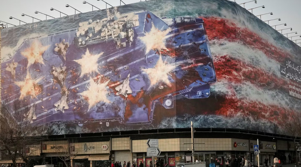 A billboard depicting a damaged US aircraft carrier with disabled fighter jets on its deck
